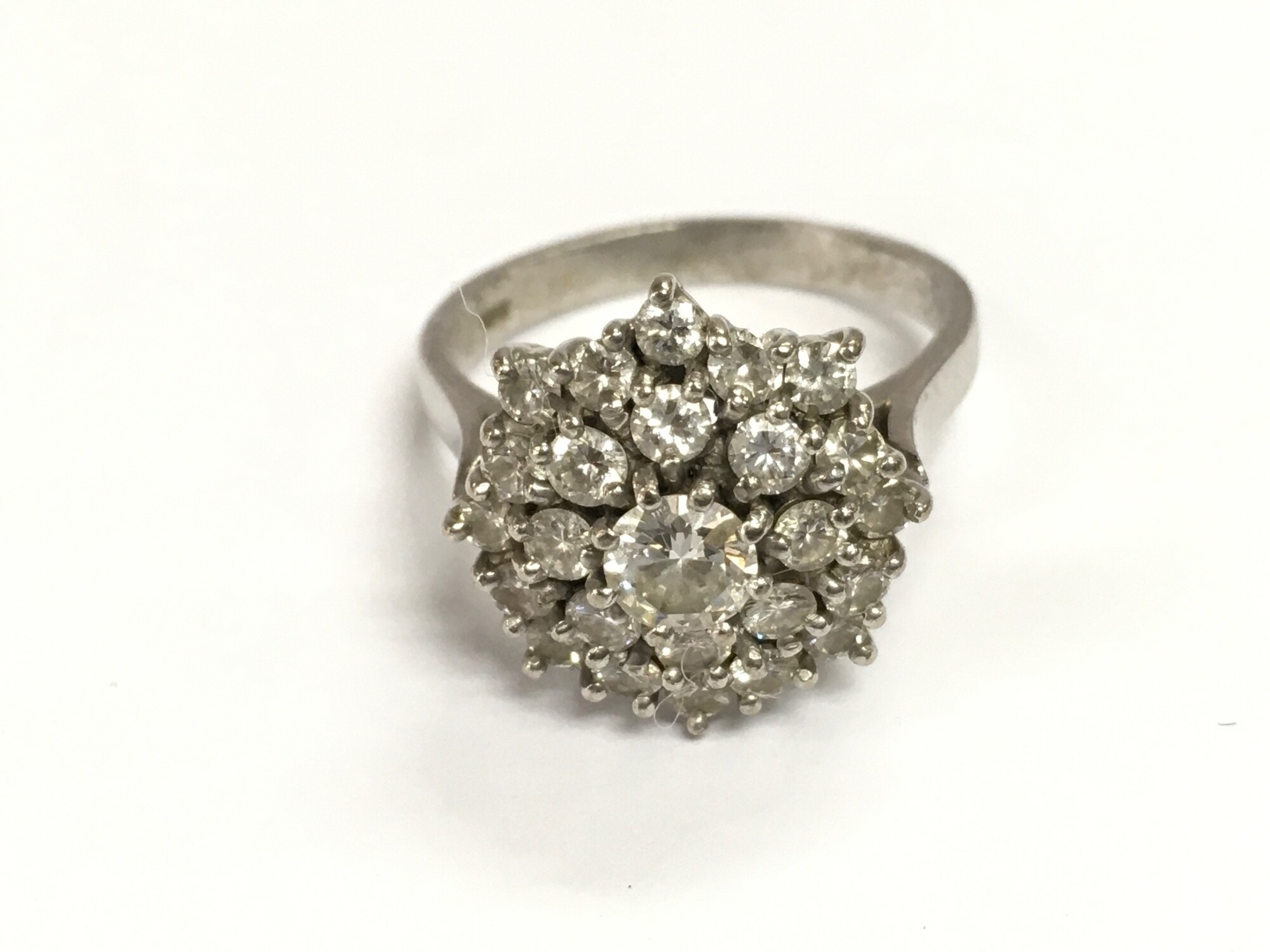 An 18ct white gold diamond cluster ring.