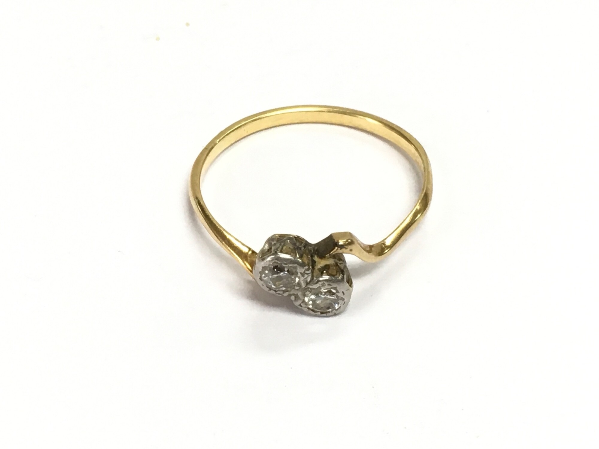 A yellow metal diamond crossover ring, approx 2.2g and approx size S.