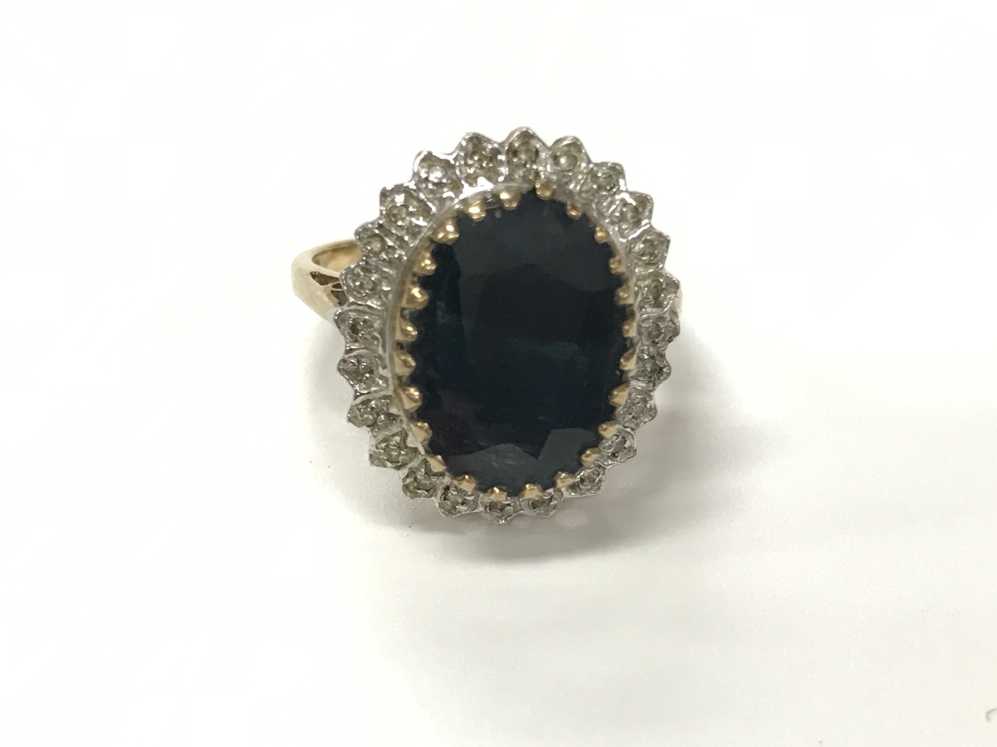 A 9ct gold ring set with large oval cut smoked quartz. Size O and 4.21g