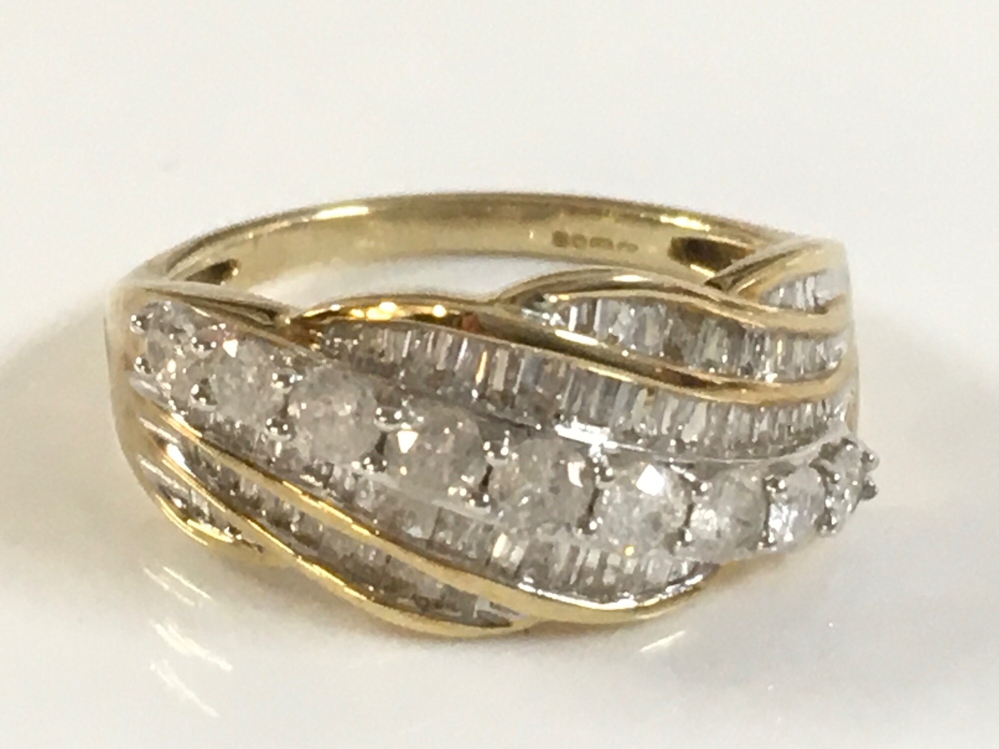 A 9 carat gold ring set with white stones. 3.4g size O