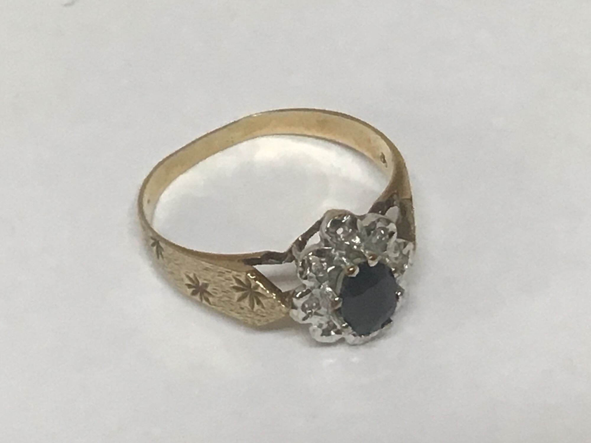 A 9 carat gold ladies ring set with a blue sapphire and chip stones weight 2grams