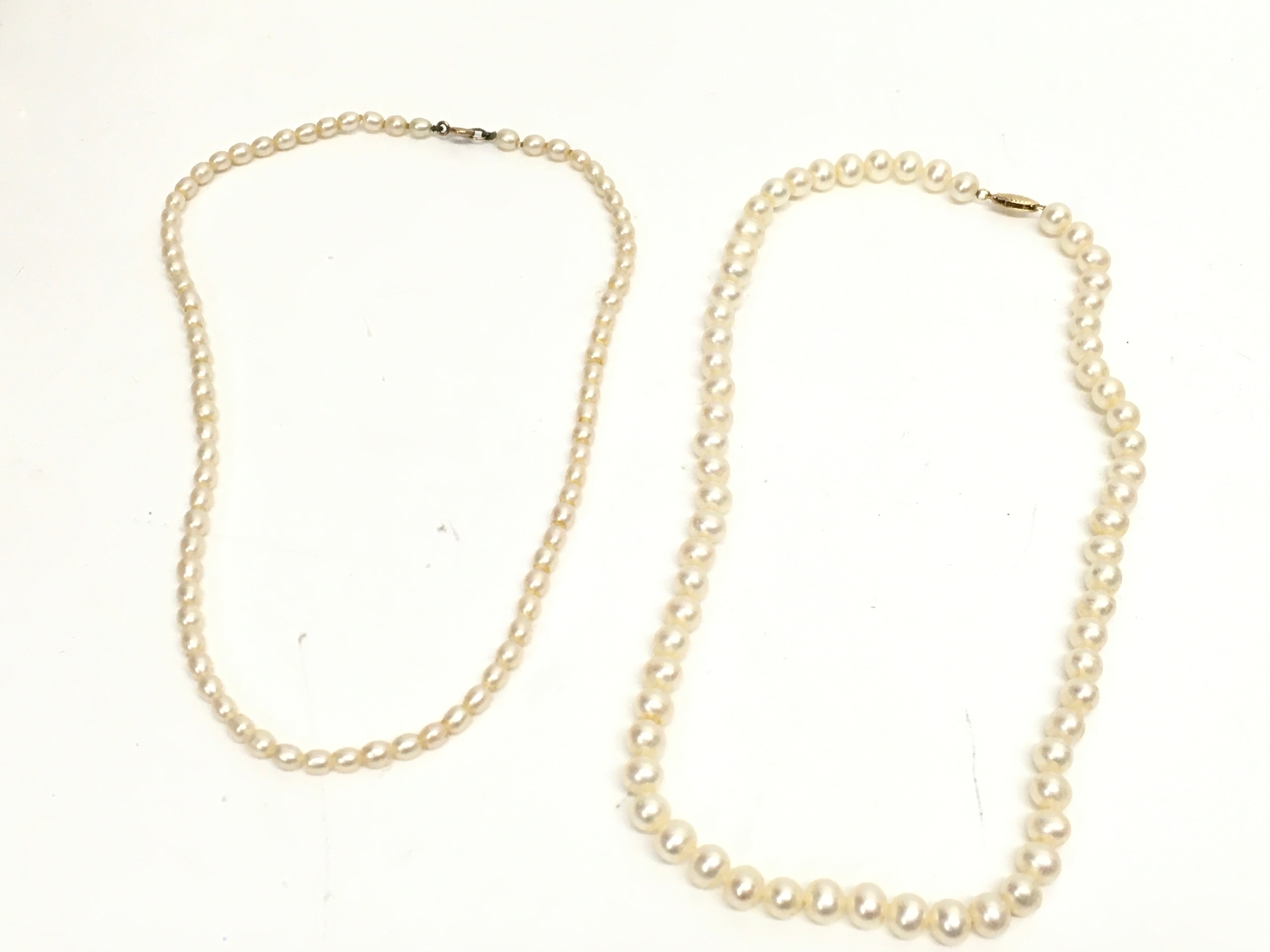 Two pearl and gold necklaces . 9 and 14ct clasps. 20cm long