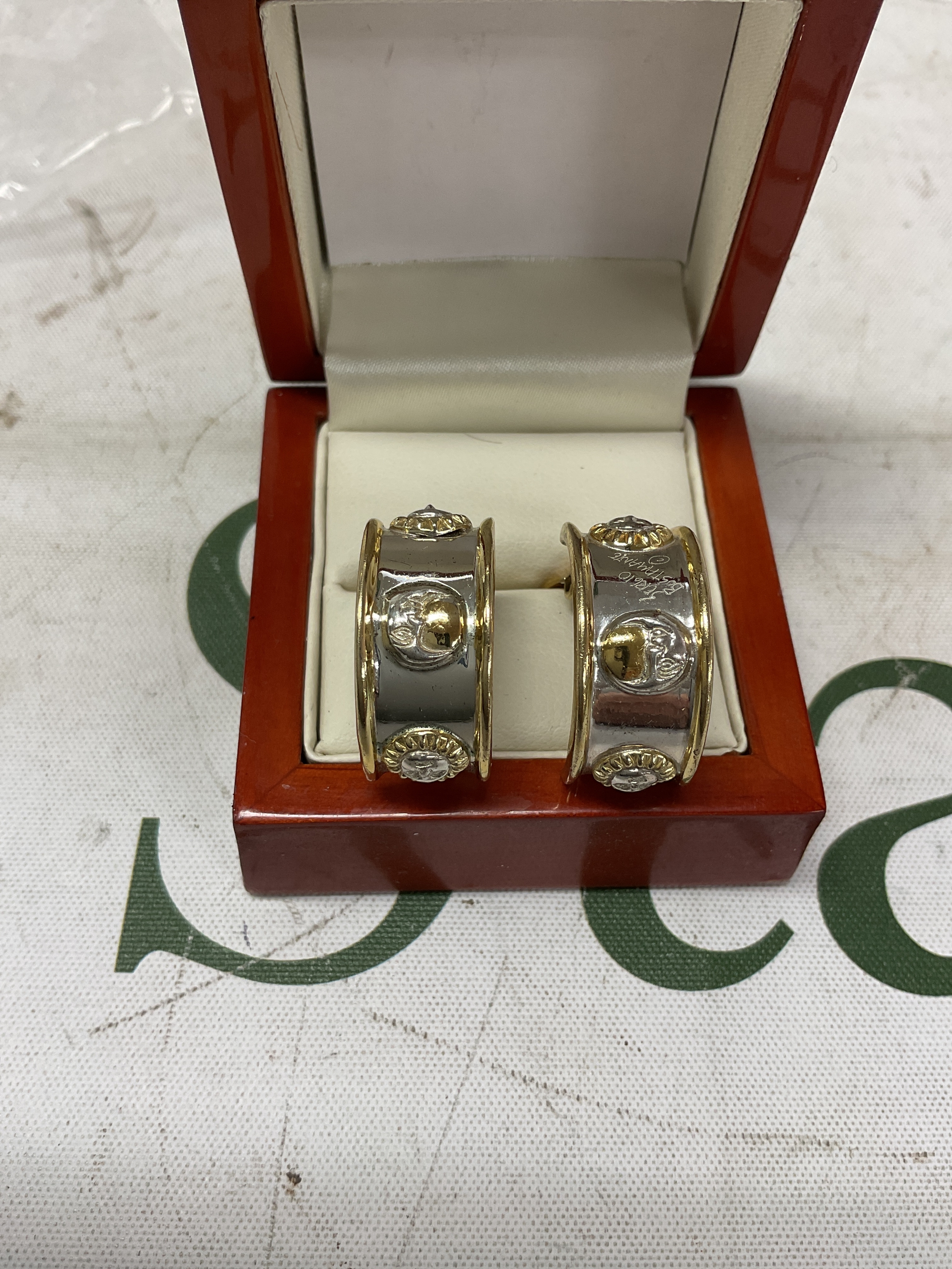 Sergio Bastemente clip on bi coloured earrings, with lion masks and moons and hand signed to one on the outer edge and hallmarks to the inside.