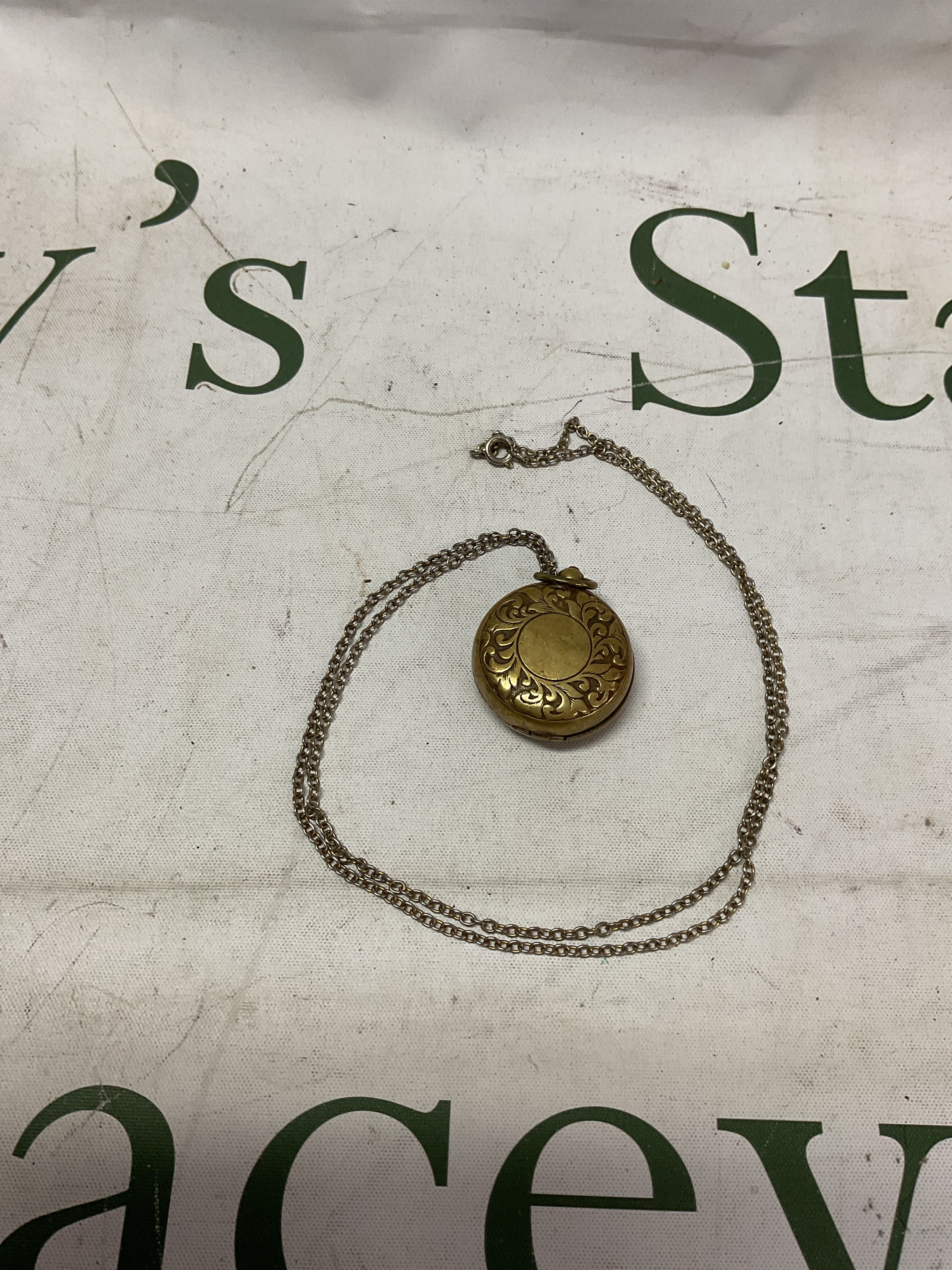 Brass Edwardian sovereign case on chain.