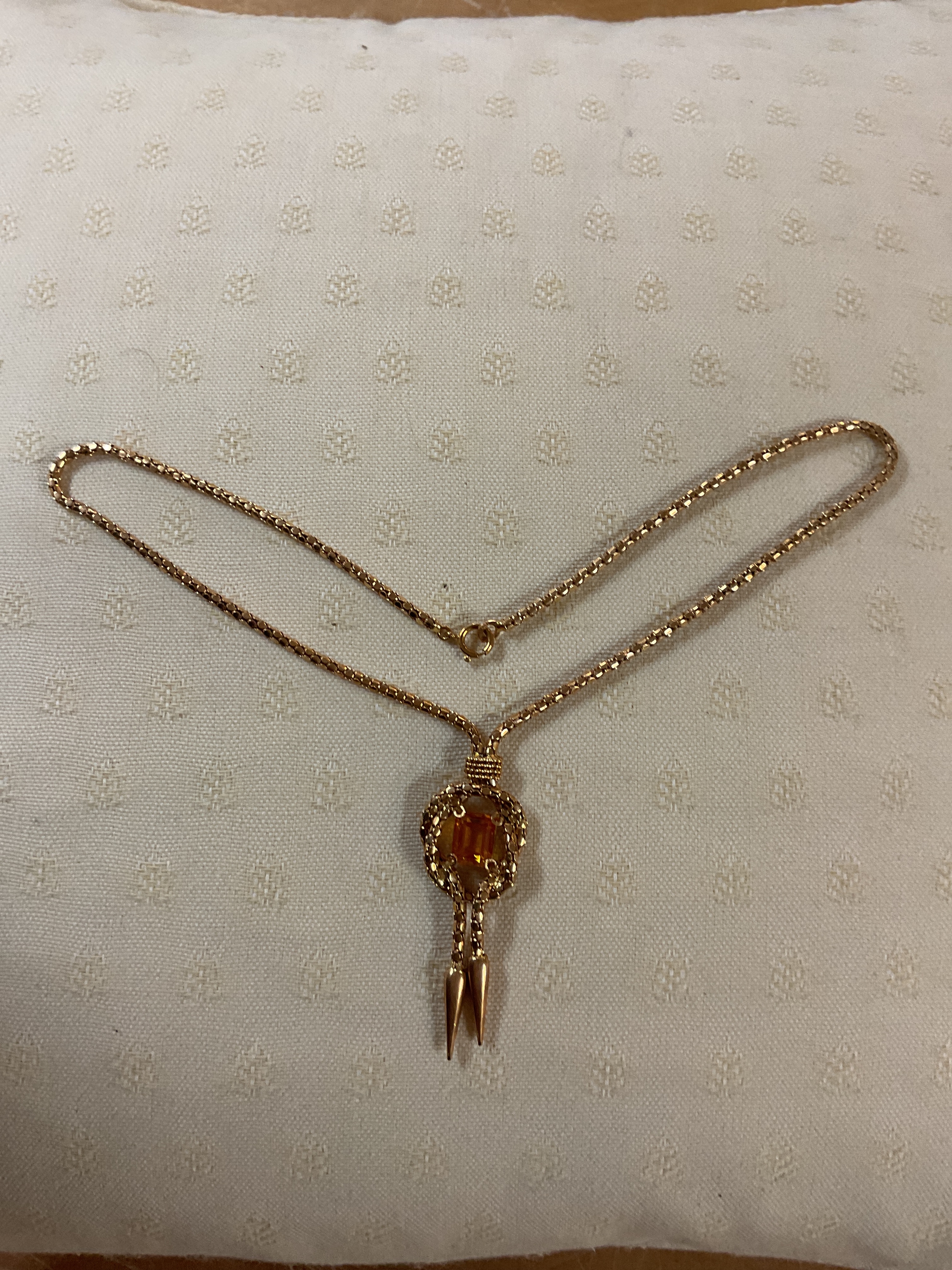 18ct fancy link necklace with swag finials set with an emerald cut orange Sapphire to the centre, weight 17 grams.