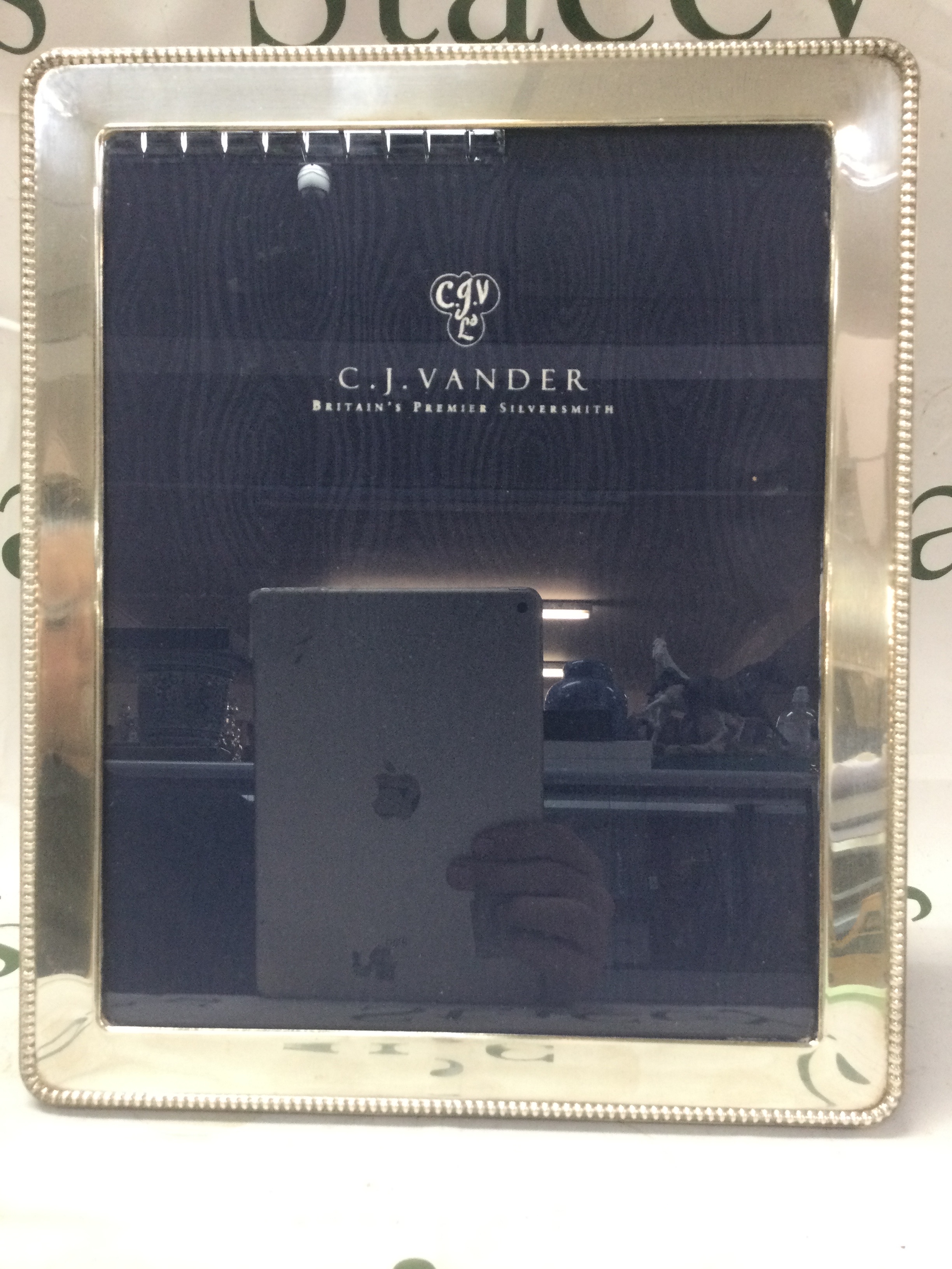 A large C.J. Vander silver photo frame.