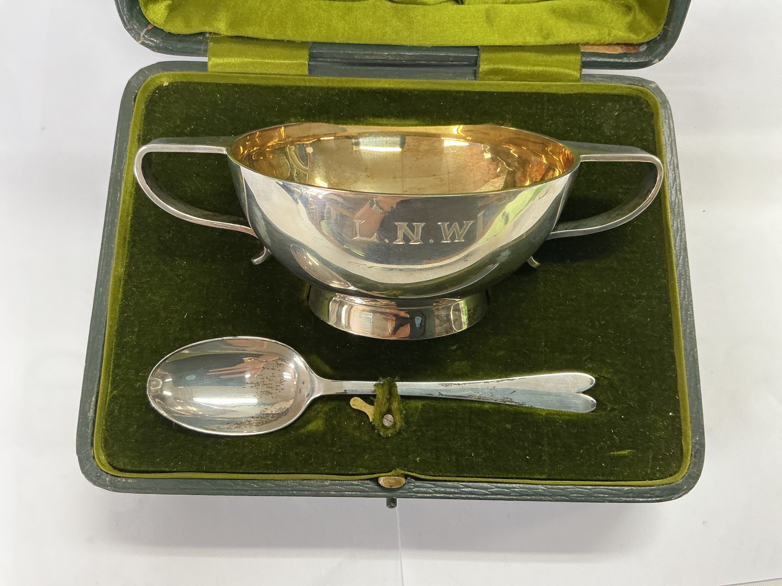 A cased silver sugar bowl and spoon, different hallmarks, approx total weight 211g.