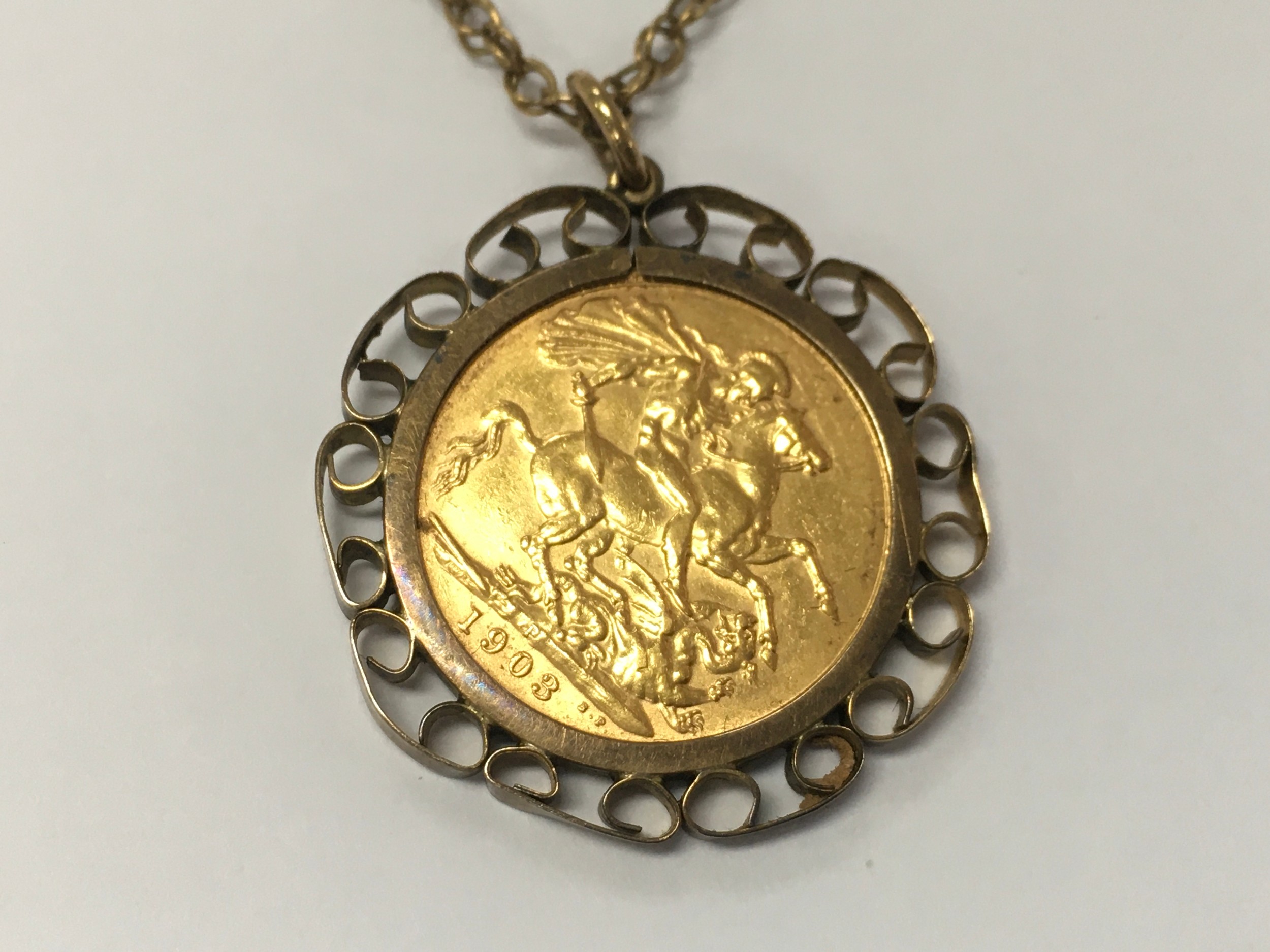 A 1908 Full sovereign with a 9ct coin mount and chain