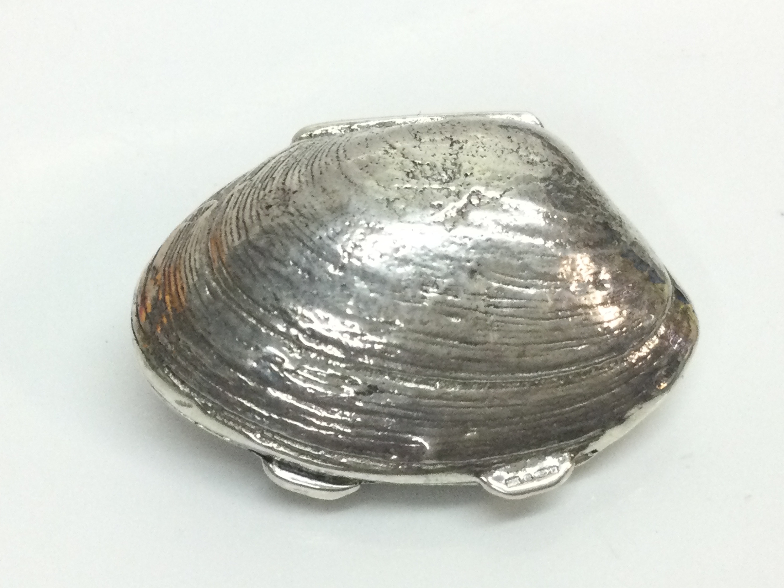 A Silver hallmarked pillbox in the form of a shell, 3.5Cm wide .19g total weight 