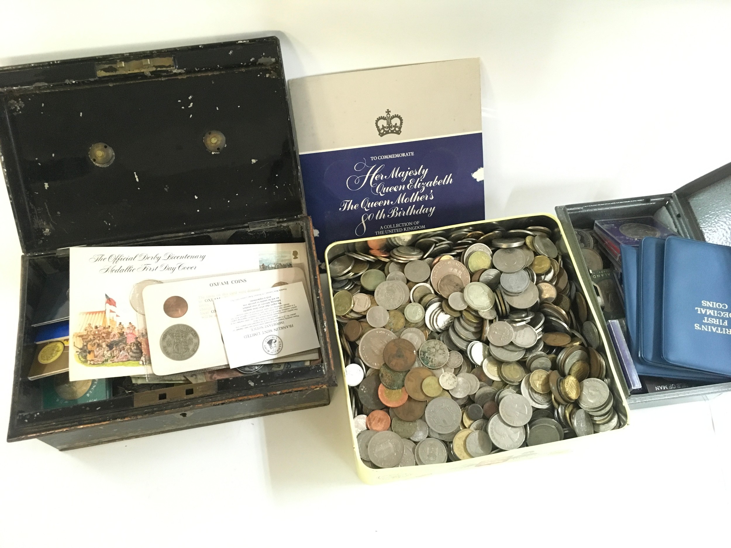 Three tins of mixed coins and banknotes including many silver coins
