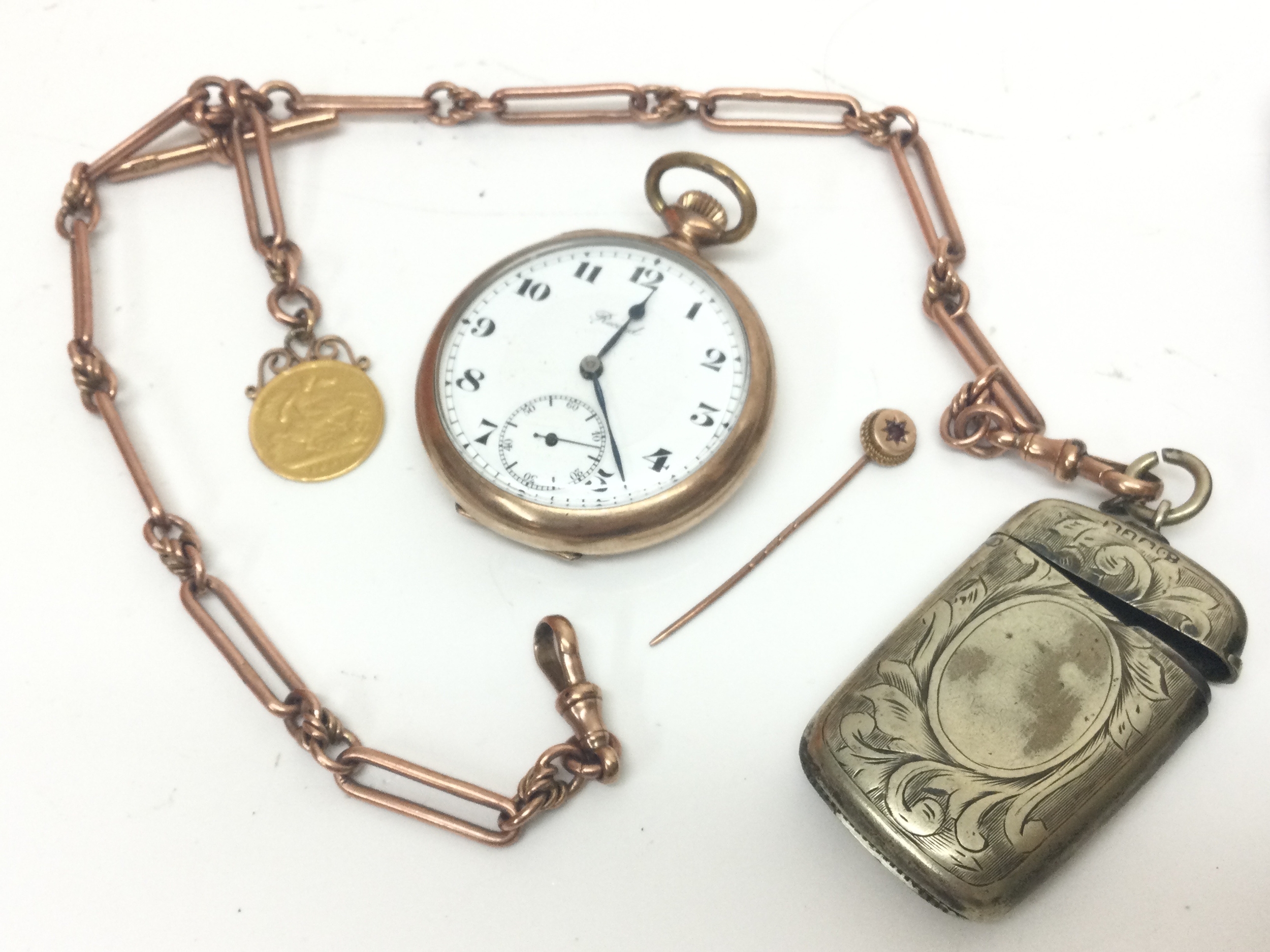A 9ct gold chain with a 1897 half sovereign (44.6g total weight), silver hallmarked Vesta, tie pin and a non gold 'Record' pocket watch