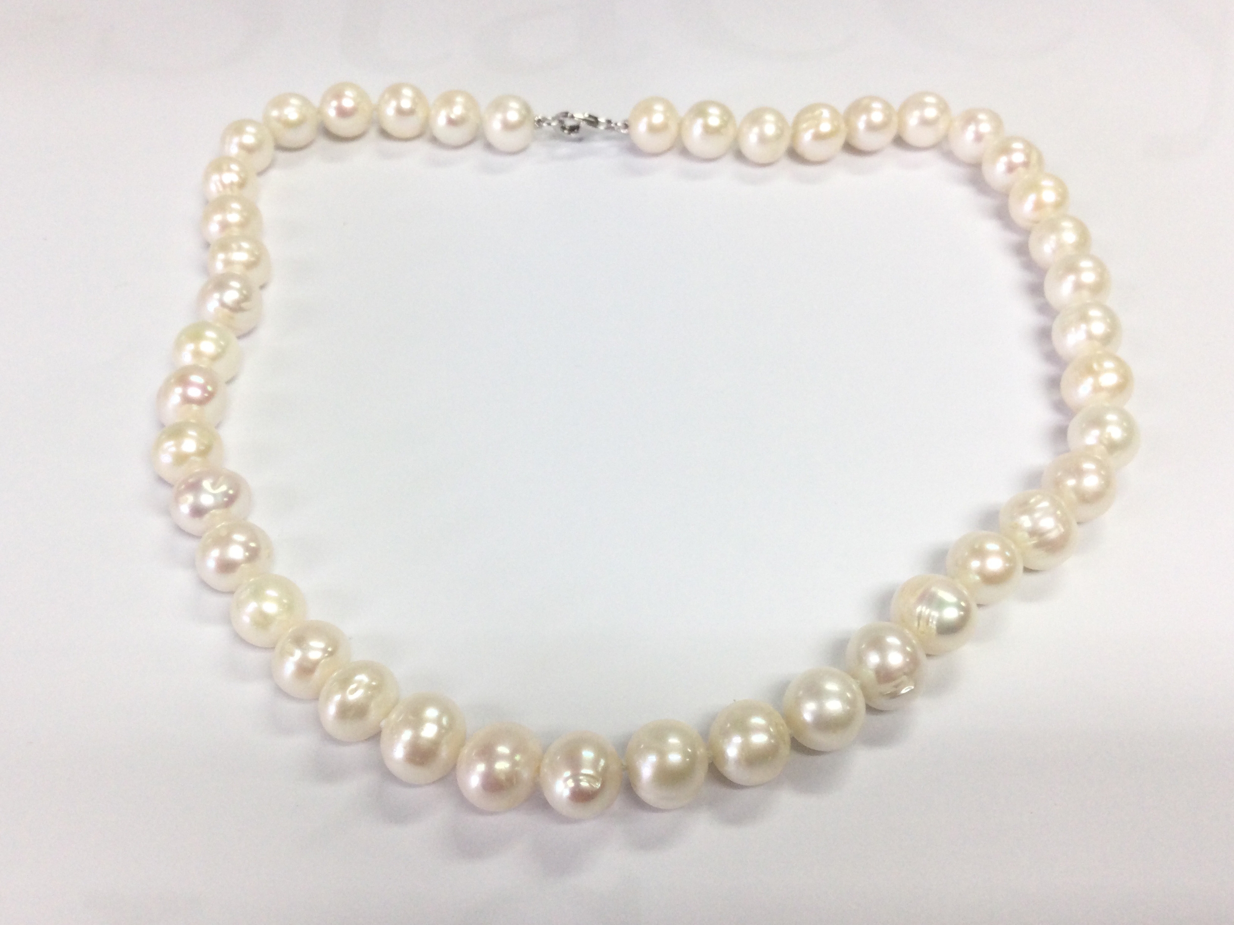 18" white cultured pearl necklace with silver clasp.