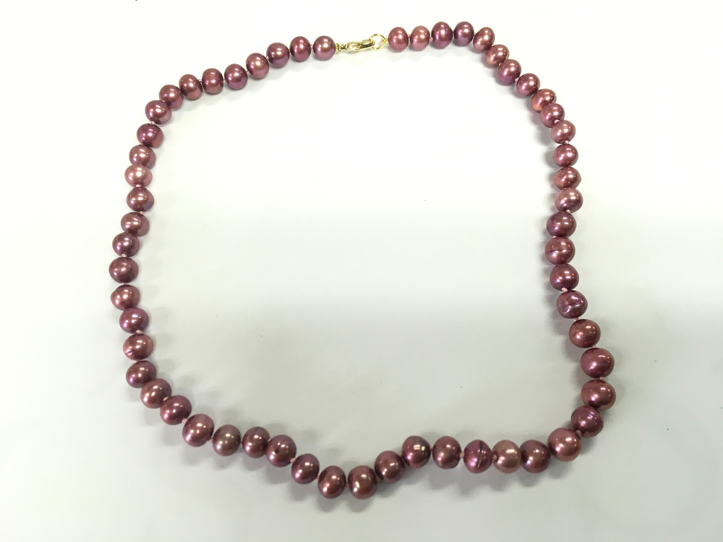 18" dark pink - purple cultured pearl strung necklace with gold plated lobster claw clasp.