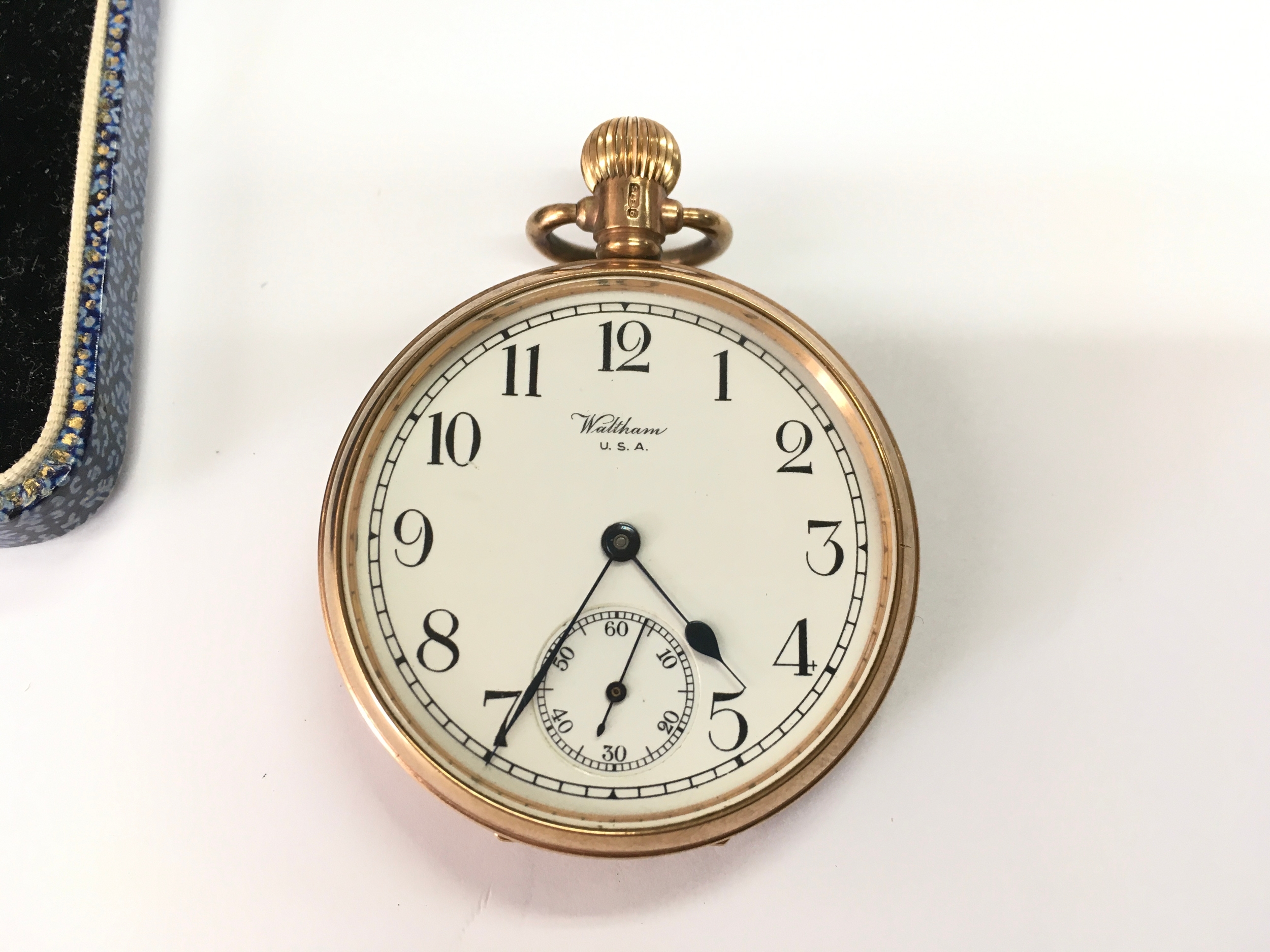 A 9ct gold waltham button wind pocket watch. Winds and runs.