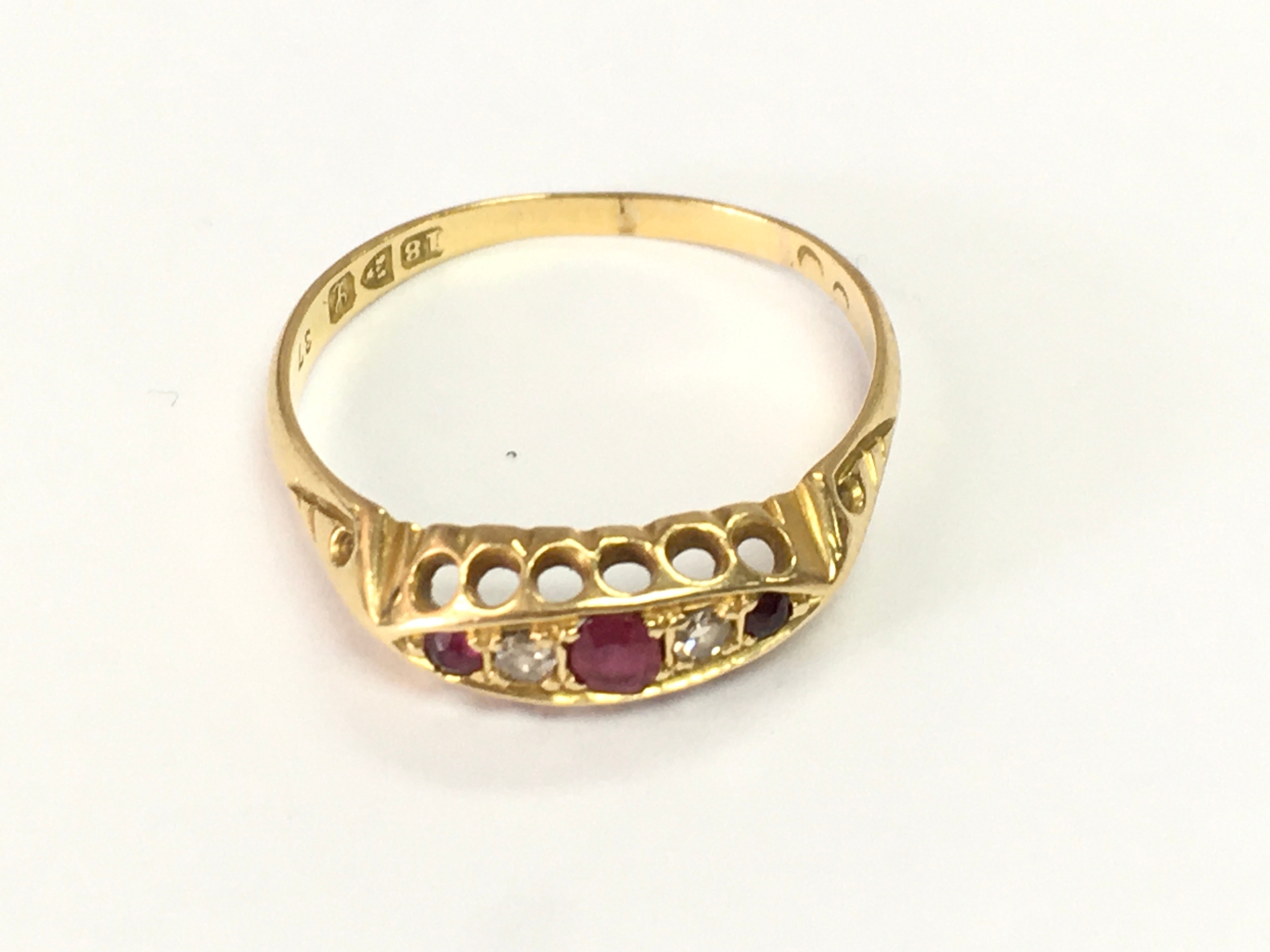 An 18ct good ring set with rubies and diamonds. size R and 2.5g