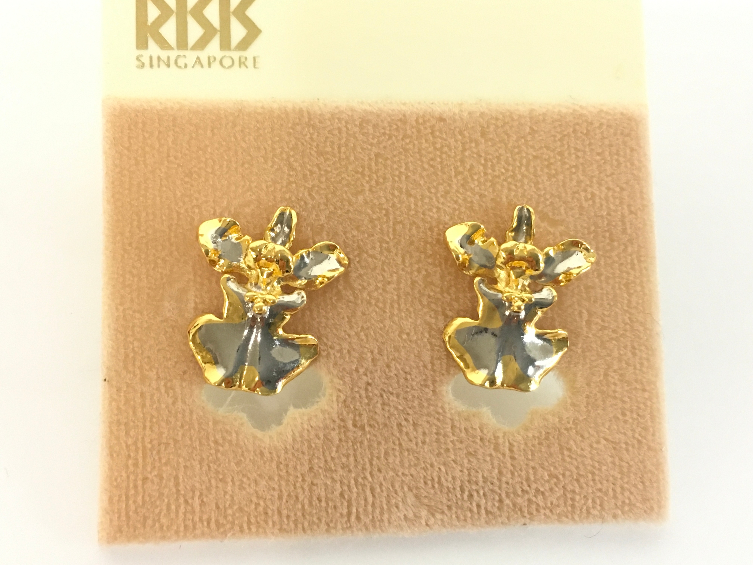 A pair of yellow metal earrings.