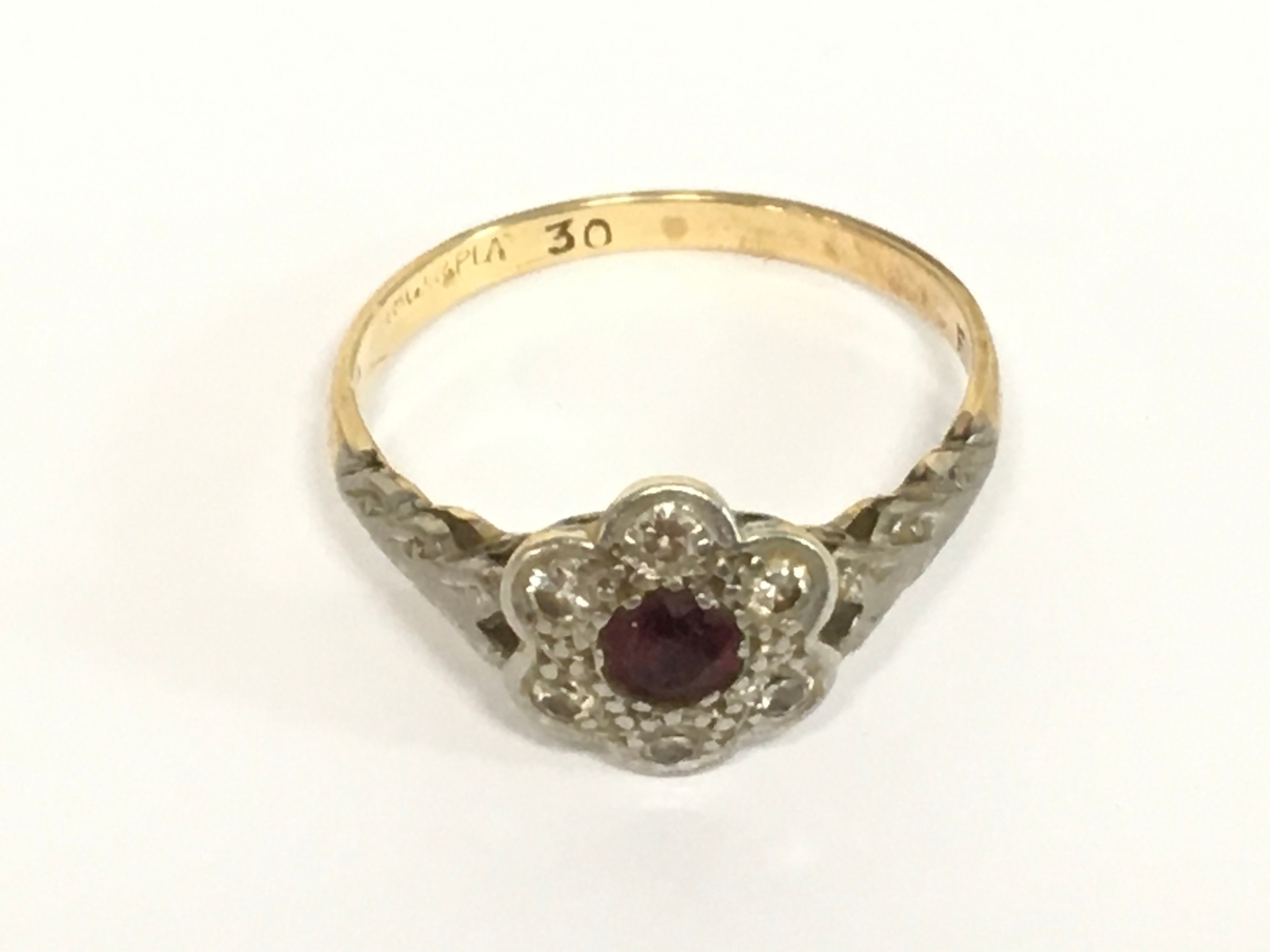 An 18ct gold ring set with ruby and diamonds. 2.6g and size O