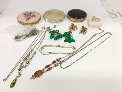 A mixed of costume jewellery and compacts.