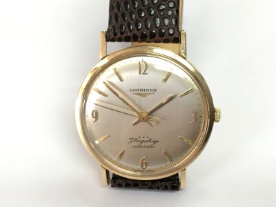 A 9ct gents Longines flagship automatic wristwatch. With brown leather strap. Winds and runs.