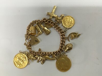 A 9ct gold charm bracelet with two full sovereign and a half shield back sovereign.
56.66g total.