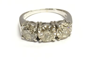 An 18ct white gold three stone diamond rings. Approximately 0.85ct each. Size O and 6.20g