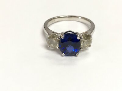 An 18ct white gold synthetic sapphire and diamond ring. Comes with cert. Ring size M