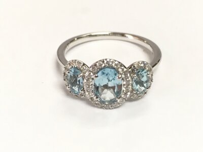 9ct white gold trilogy cluster ring set with aquamarines and diamonds. Size M and approximately 0.84ct aquamarine and 0.23ct diamonds.