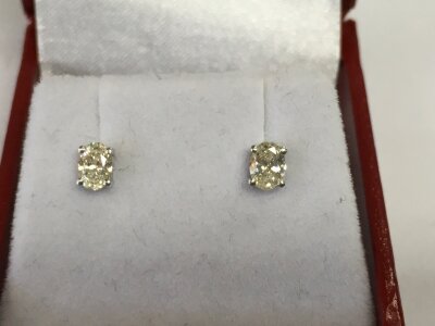 A pair of 18ct white gold 4 claw oval set diamond solitaire studs. Diamonds approximately 0.60ct.
