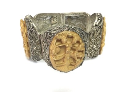 An interesting silver Chinese filigree bracelet with panels carved from bone depicting a woman among plants. NO RESERVE
