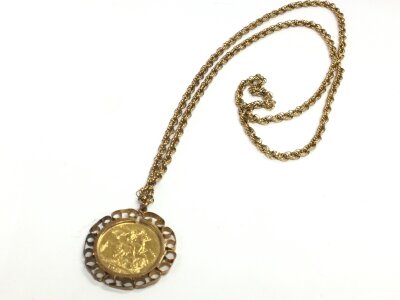 A 1911 full sovereign in a 9ct mount and chain. 23g