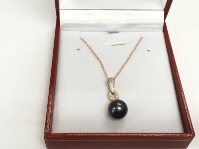 A 9ct gold rose pendant set with a suspended iridescent dark pearl and diamond-set bale in an Art Deco Style on a 9ct rose gold chain boxed. Diamonds 0.09ct