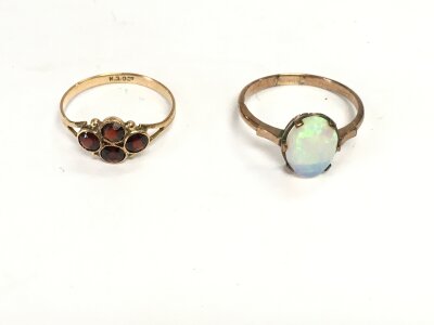 A 9ct gold garnet ring size m and a 9ct opal ring size P 2.93g total.