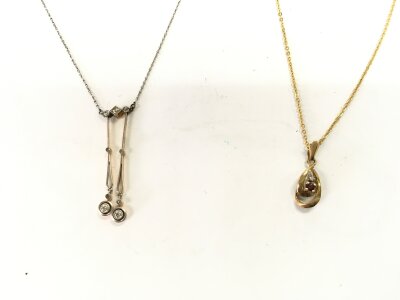 Two 9ct gold diamond set pendants.