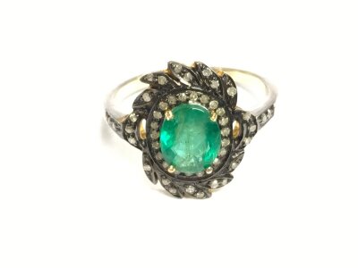 Silver and silver gilt ring set with an oval emerald surrounded by diamonds. Approximately 1ct emerald and 0.24ct diamonds size L.