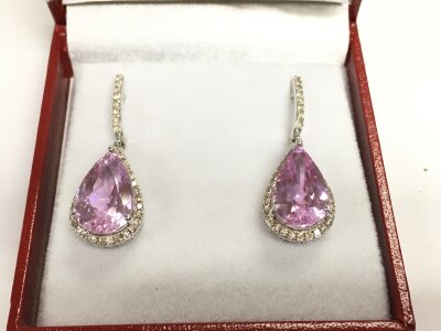 A pair of 14ct white gold earring set with pear shaped kunzites each surrounded by diamonds.