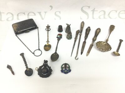 A silver purse and a quantity of spoons thimbles, two military badges and other oddments. 240g total weight