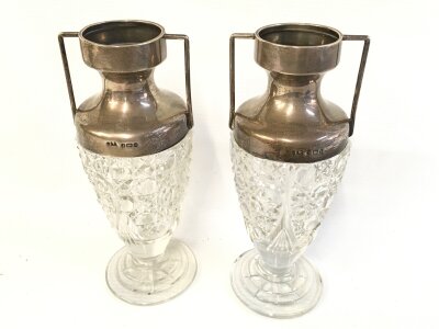 Two silver topped vases. 17cm tall