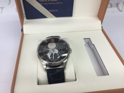 A boxed Oupinke moon face watch