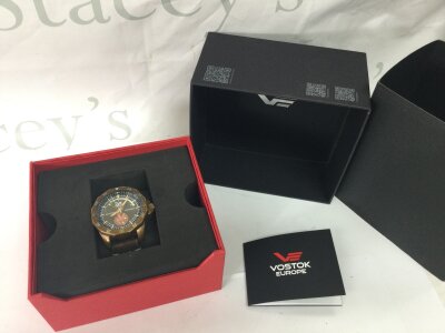 A boxed Vostok Gents watch, seen working