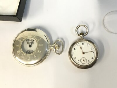 Two silver cased pocket watches. One 50mm case other is 35mm