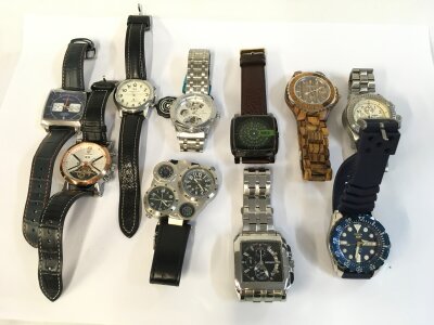 A collection of assorted men’s fashion and copy watches.