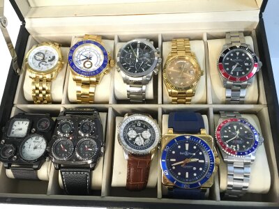 A collection of copy watches and a Casio Edifice watch all in a watch box