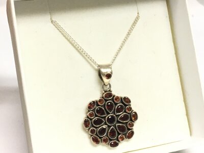 A silver garnet pendant with chain
