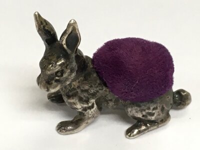 A heavy miniature silver hallmarked (on tail) hare pin cushion