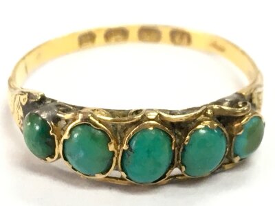 A 12ct gold five stone turquoise set ring, size O. 1.5g