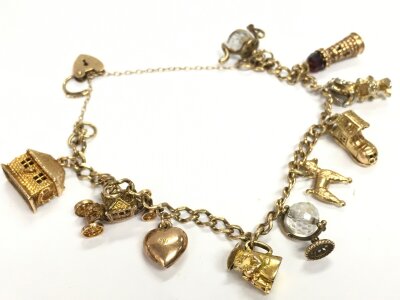 A 9ct gold charm bracelet and charms, 25.6g total weight