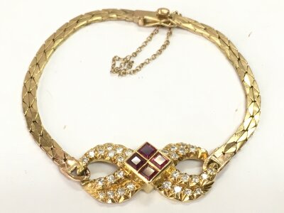 9ct and 18ct bracelet with a ruby and diamond face. 11.7g 6cm wide