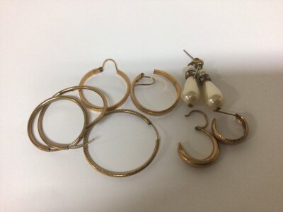 A collection of 9 carat gold and other earrings.