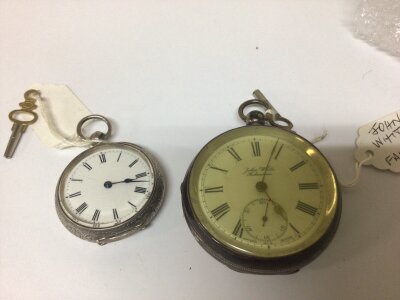 A Silver cased key wind pocket watches maker John White Fakenham seen working and one other smaller silver cased pocket watch with an elaborate engraved case (2)