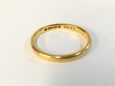 A 22ct gold wedding band. Size P and 3.26